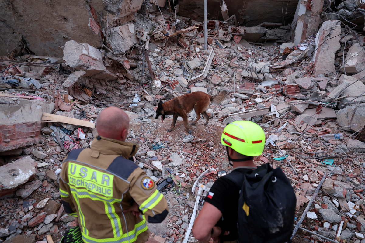 Szizor Namornik, a search-and-rescue dog from the Czech Republic, deployed by Urban Search and Rescue (USAR), walks on top of rubble during search and rescue operations at the site of a collapsed building in the aftermath of earthquakes, in La Guaira, Venezuela, June 30, 2026. REUTERS/Ricardo Arduengo