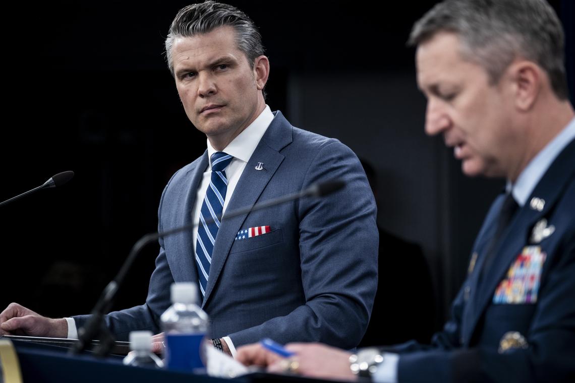 Secretary of Defense Pete Hegseth, left, and Chairman of the Joint Chiefs of Staff Gen. Dan Caine, right, provide updates on the war in Iran at the Pentagon in Arlington, Va., Thursday, April 16, 2026. (Pete Marovich/The New York Times)