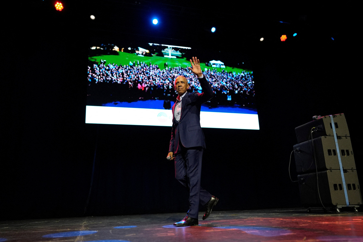 Former President Barack Obama gestures as he walks off stage after surprising administration and campaign alumni in Chicago ahead of the dedication ceremony of the Obama Presidential Center, Wednesday, June 17, 2026.     Pablo Martinez Monsivais/Pool via REUTERS