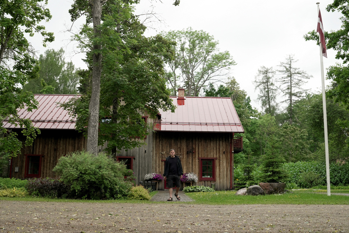 Owner of rural guest house Martins Kiscenko walks in front of his guest house in Rezekne county, Latvia, June 8, 2026. REUTERS/Janis Laizans