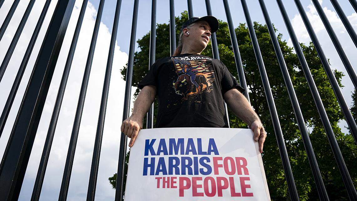 A Kamala Harris supporter stands in front of the White House in Washington on Sunday. The vice president is expected to win the Democratic nomination based on DNC delegate votes.