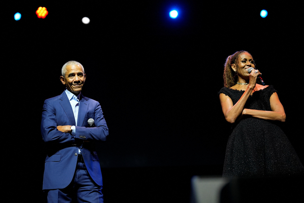 Former President Barack Obama and former first lady Michelle Obama on stage as they surprised administration and campaign alumni in Chicago ahead of the dedication ceremony of the Obama Presidential Center, Wednesday, June 17, 2026.     Pablo Martinez Monsivais/Pool via REUTERS