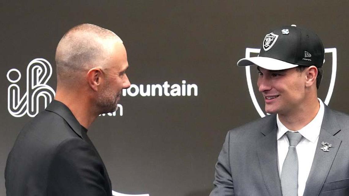  Apr 24, 2026; Henderson, NV, USA; Las Vegas Raiders quarterback Fernando Mendoza (right) shakes hands with general manager John Spytek at the introductory press conference at Intermountain Health Performance Center after being selected as the No. 1 pick in the 2026 NFL Draft. Mandatory Credit: Kirby Lee-Imagn Images | Kirby Lee-Imagn Images 