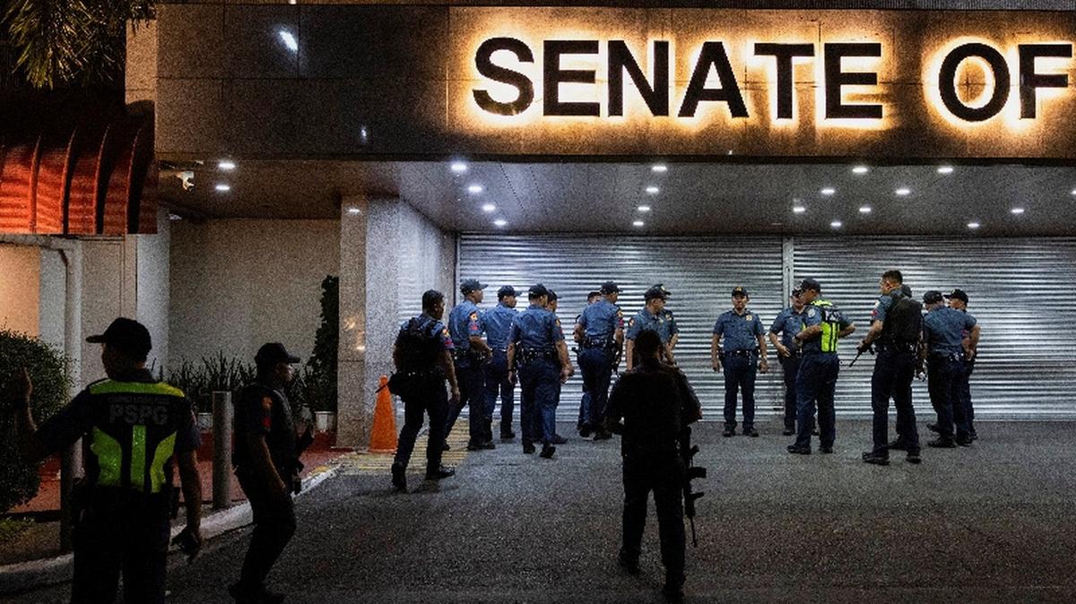 Police officers stand outside the Senate building, after gunshots were heard at the Philippine Senate, as chaos mounted in anticipation of an attempt to arrest a top senator wanted by the International Criminal Court, in Pasay City, Metro Manila, Philippines, May 13, 2026. REUTERS/Eloisa Lopez