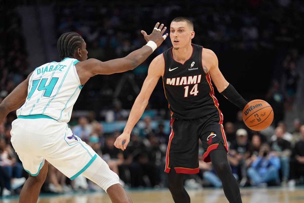  Apr 14, 2026; Charlotte, North Carolina, USA; Miami Heat guard Tyler Herro (14) handles the ball against Charlotte Hornets forward Moussa Diabat (14) during the second quarter during the play-in rounds between the Charlotte Hornets and the Miami Heat of the 2026 NBA Playoffs at Spectrum Center. Mandatory Credit: Jim Dedmon-Imagn Images 