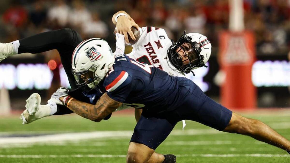  Oct 5, 2024; Tucson, Arizona, USA; Arizona Wildcats defensive back Dalton Johnson (43) tackles Texas Tech Red Raiders quarterback Behren Morton (2) during third quarter at Arizona Stadium. Mandatory Credit: Aryanna Frank-Imagn Images | Aryanna Frank-Imagn Images 