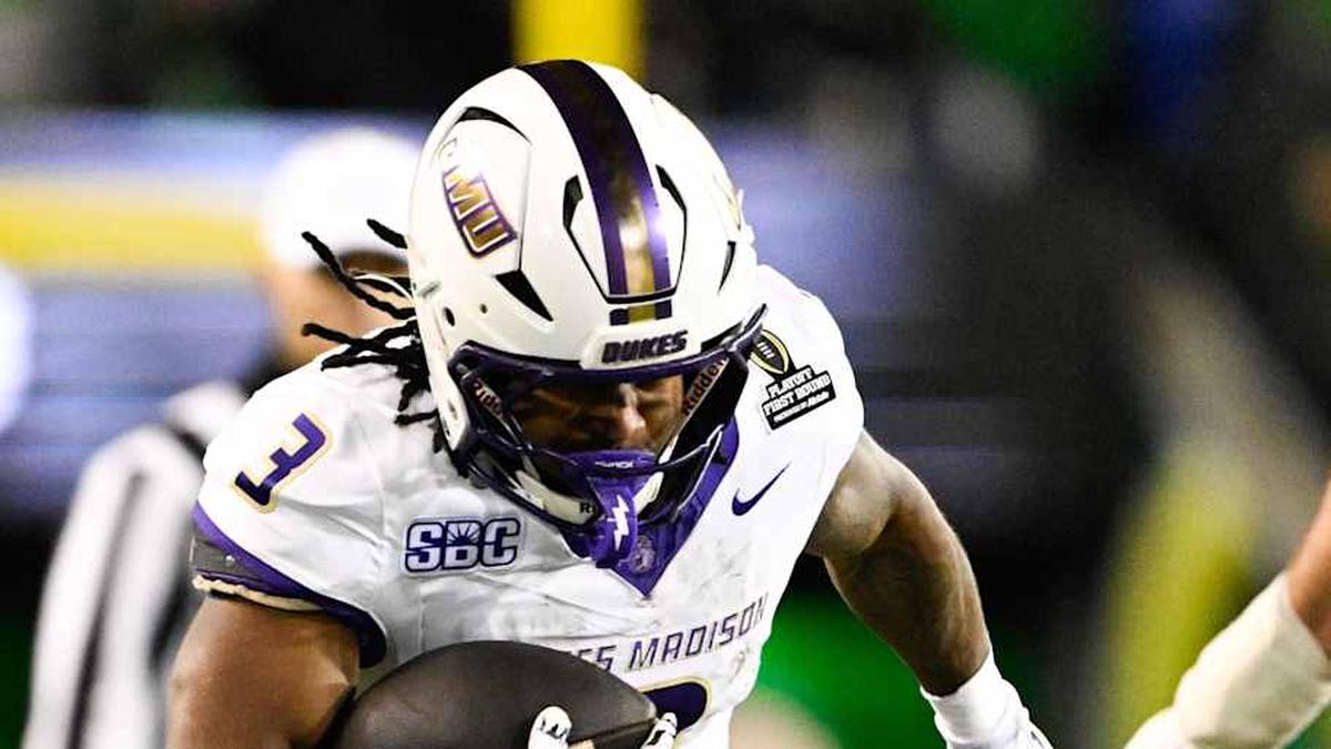  Dec 20, 2025; Eugene, OR, USA; James Madison Dukes running back Wayne Knight (3) rushes as Oregon Ducks defensive back Aaron Flowers (21) defends during the second quarter at Autzen Stadium. Mandatory Credit: Troy Wayrynen-Imagn Images | Troy Wayrynen-Imagn Images 