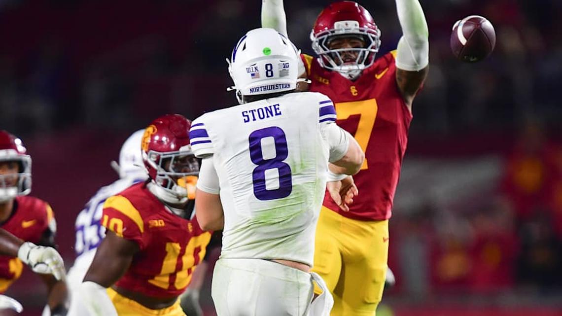  Nov 7, 2025; Los Angeles, California, USA; Northwestern Wildcats quarterback Preston Stone (8) throws under pressure from Southern California Trojans safety Kamari Ramsey (7) during the second half at the Los Angeles Memorial Coliseum. Mandatory Credit: Gary A. Vasquez-Imagn Images | Gary A. Vasquez-Imagn Images 