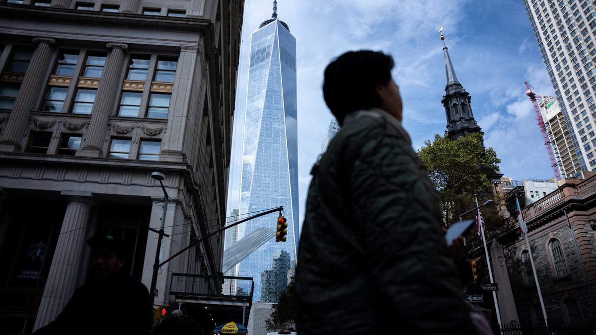 People walk around the Financial District in New York City, U.S., November 5, 2025. REUTERS/Angelina Katsanis