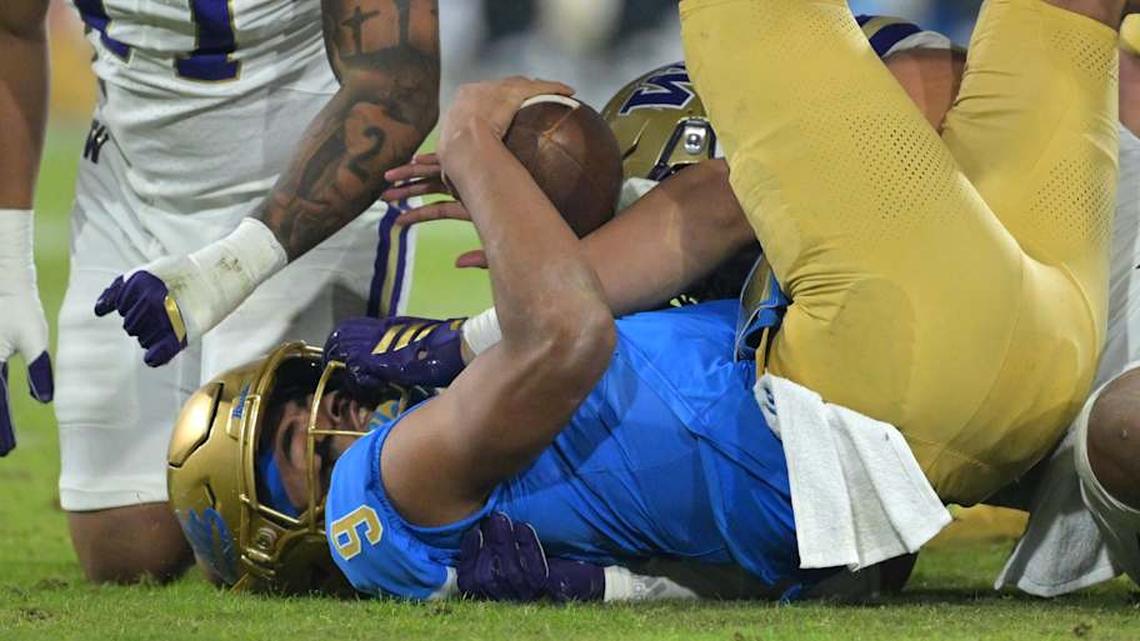  Nov 22, 2025; Pasadena, California, USA; UCLA Bruins quarterback Nico Iamaleava (9) is sacked by Washington Huskies linebacker Deven Bryant (17) and defensive lineman Bryce Butler (92) during the second half at the Rose Bowl. Mandatory Credit: Jayne Kamin-Oncea-Imagn Images | Jayne Kamin-Oncea-Imagn Images 