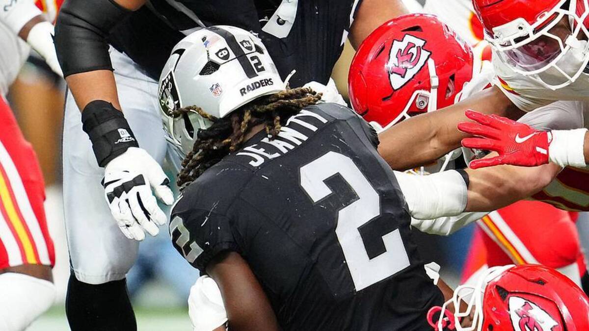  Jan 4, 2026; Paradise, Nevada, USA; Las Vegas Raiders running back Ashton Jeanty (2) is tackled by Kansas City Chiefs defensive tackle Derrick Nnadi (92) during the second quarter at Allegiant Stadium. Mandatory Credit: Stephen R. Sylvanie-Imagn Images | Stephen R. Sylvanie-Imagn Images 