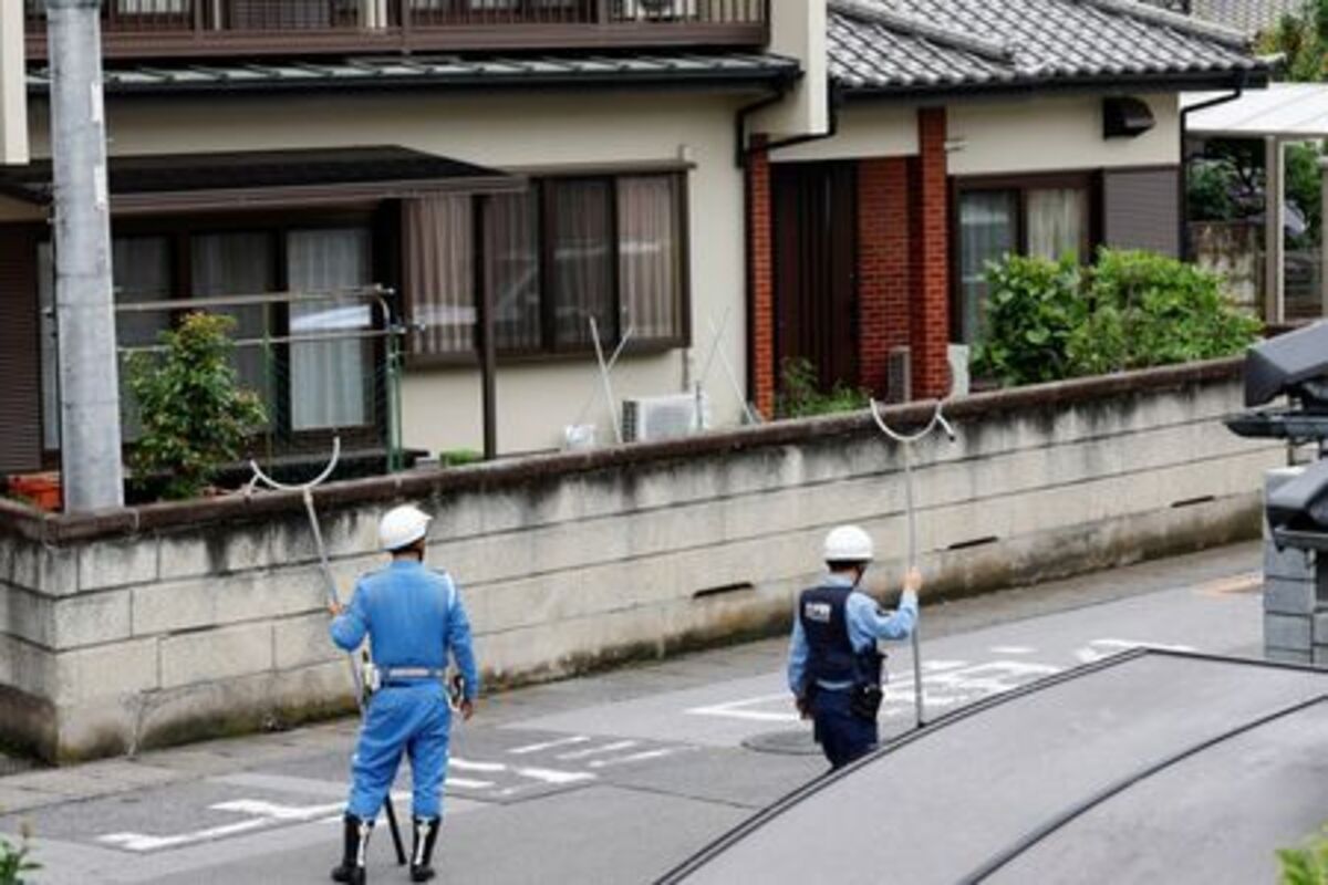 Policemen with sticks shields search for a bear at a residential area after a black bear was spotted in Utsunomiya, Tochigi Prefecture, Japan, June 9, 2026. REUTERS/Kim Kyung-Hoon