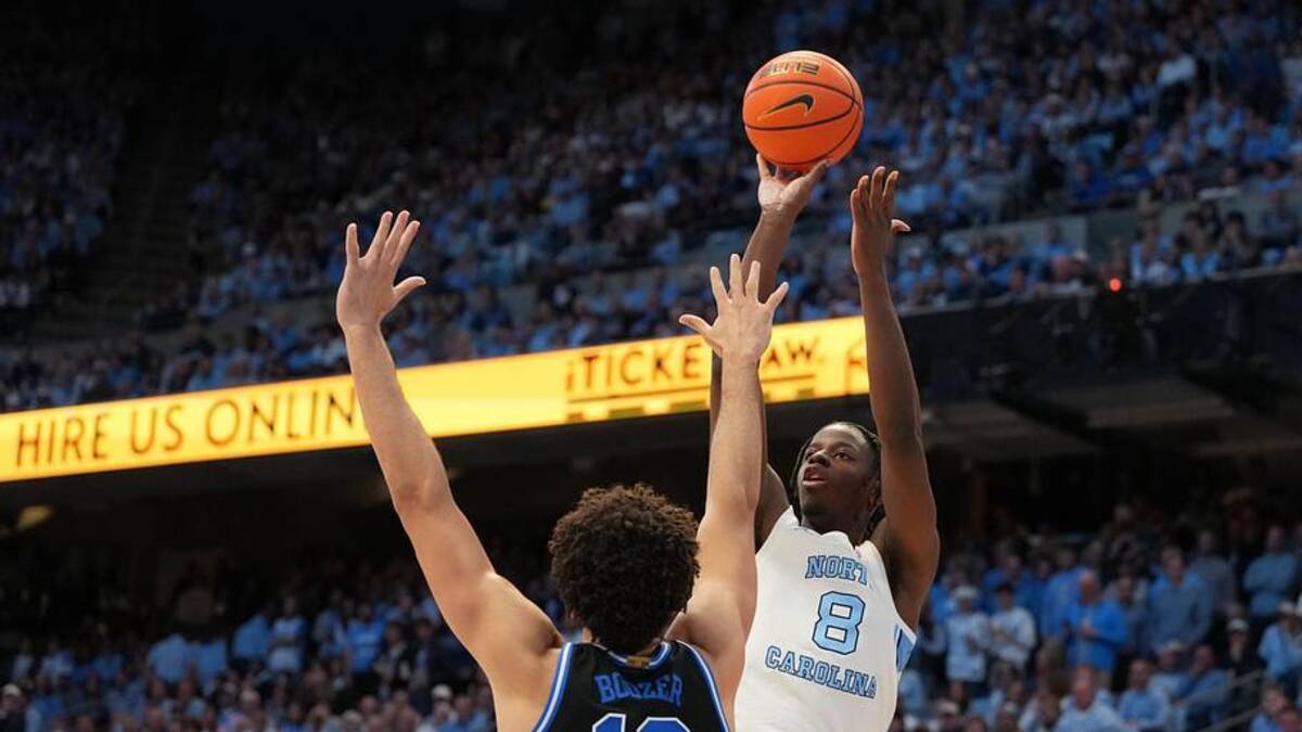  North Carolina forward Caleb Wilson shoots over Duke forward Cameron Boozer during their game last season. Wilson projects as a Kevin Garnett–type player, while Boozer's high-end comp is Kevin Love. | Bob Donnan-Imagn Images 