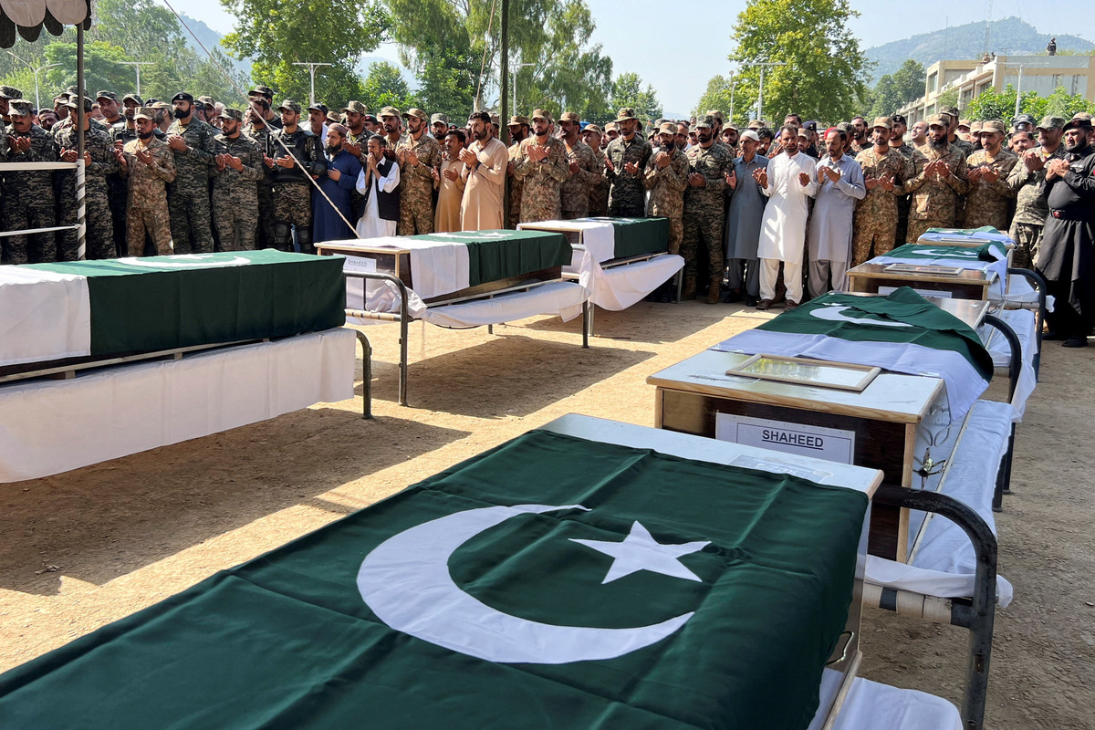 Pakistani Army officers and people offer prayers as they attend the funeral of the victims, who died after an Mi-17 helicopter of Pakistan Army Aviation crashed near Muzaffarabad on Wednesday during take-off, in Muzaffarabad, Pakistani Kashmir, June 11, 2026. Picture taken with a mobile phone. REUTERS/Naseer ud Din