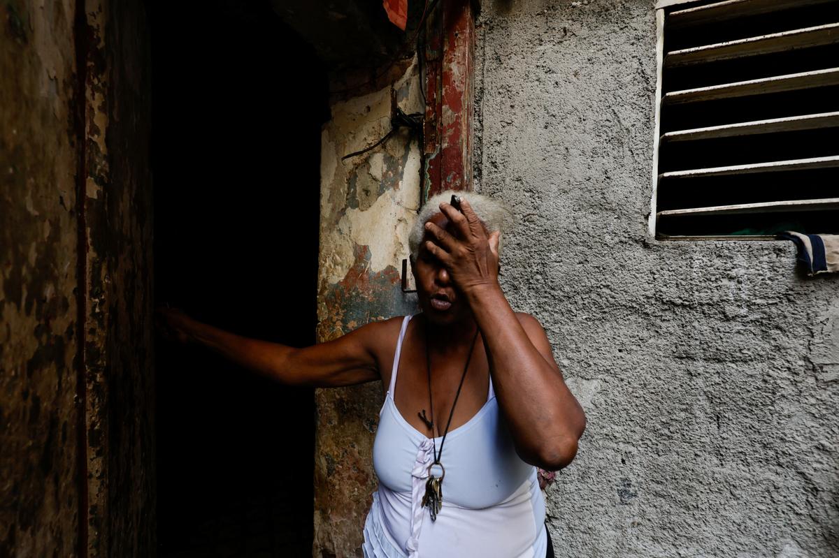 Felicia de la Caridad Alvarez, 64, a former hospital custodian, reacts the moment power went out, as Cuba's state-run economy has descended into a full-blown crisis after the administration of U.S. President Donald Trump hardened sanctions and cut off the Caribbean nation's oil supply, in Havana, Cuba May 11, 2026. REUTERS/Norlys Perez