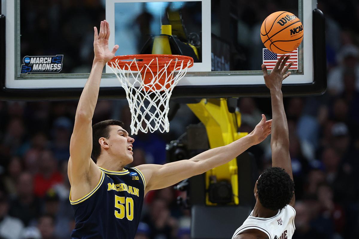 Vladislav Goldin #50 of the Michigan Wolverines defends the shot attempt by Pharrel Payne #21 of the Texas A&M Aggies during the second half in the second round of the NCAA Men’s Basketball Tournament at Ball Arena on March 22, 2025, in Denver, Colorado. (Matthew Stockman/Getty Images/TNS)