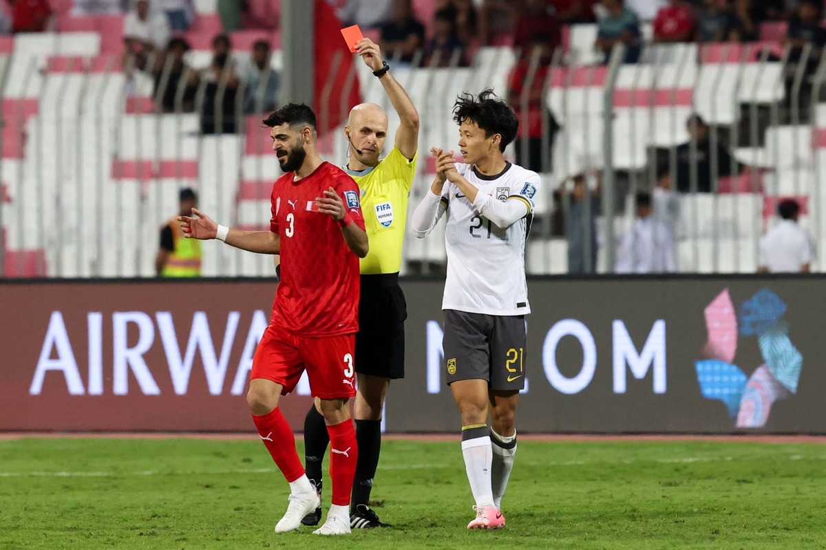  Referee Adham Mohammad Makhadmeh gives a red card to Waleed Al-Hayyam #3 of Bahrain during the FIFA World Cup Asian 3rd Qualifier Group C match between Bahrain and China on November 14, 2024. (Photo by Zhizhao Wu/Getty Images)