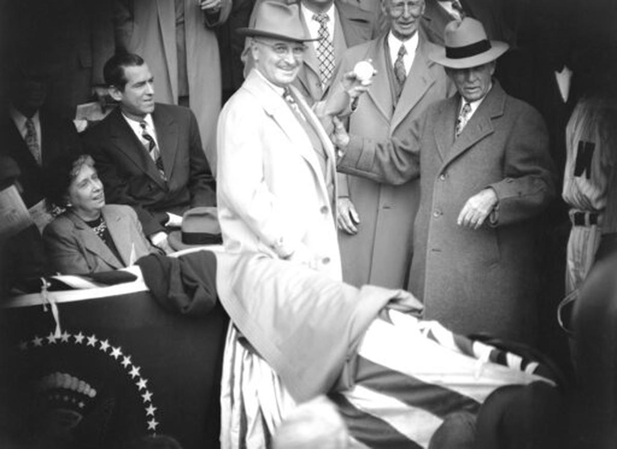 Clark Griffith, right, president of the Washington Senators, watches President Harry Truman throw out the first pitch in Washington, D.C. on April 18, 1949. Griffith is holding Truman’s arm just before the throw as Connie Mack, manager of the then-Philadelphia Athletics, looks on.