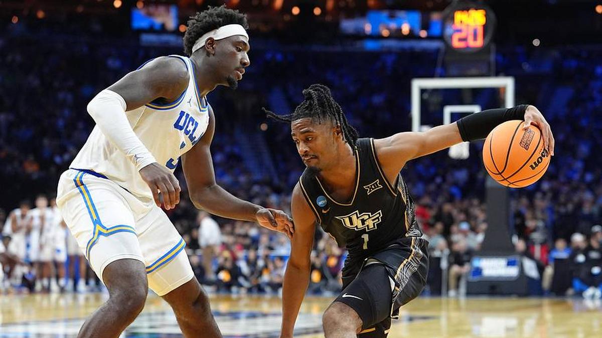  Mar 20, 2026; Philadelphia, PA, USA; UCF Knights guard Themus Fulks (1) dribbles the ball against UCLA Bruins forward Eric Dailey Jr. (3) in the second half during a first round game of the men's 2026 NCAA Tournament at Xfinity Mobile Arena. Mandatory Credit: Kyle Ross-Imagn Images | Kyle Ross-Imagn Images 