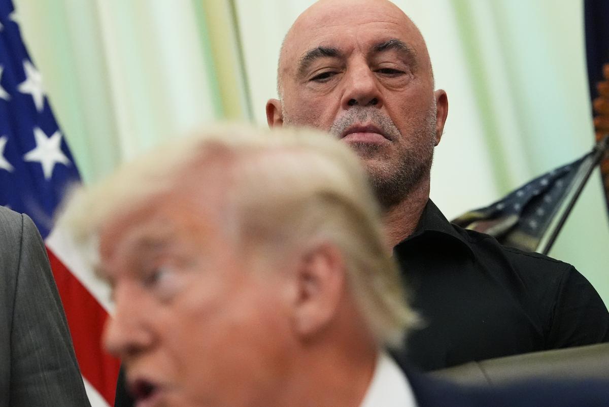  Joe Rogan listens to President Donald Trump speak in the Oval Office of the White House on April 18, 2026. 