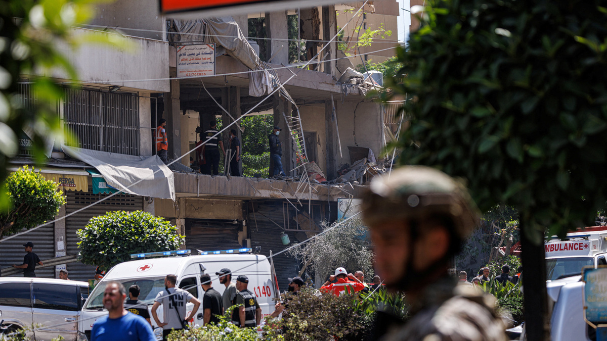 A Lebanese army officer stands as police officers and emergency personnel work at the site of an Israeli strike on the southern suburbs of Beirut, Lebanon, June 14, 2026. REUTERS/Zohra Bensemra