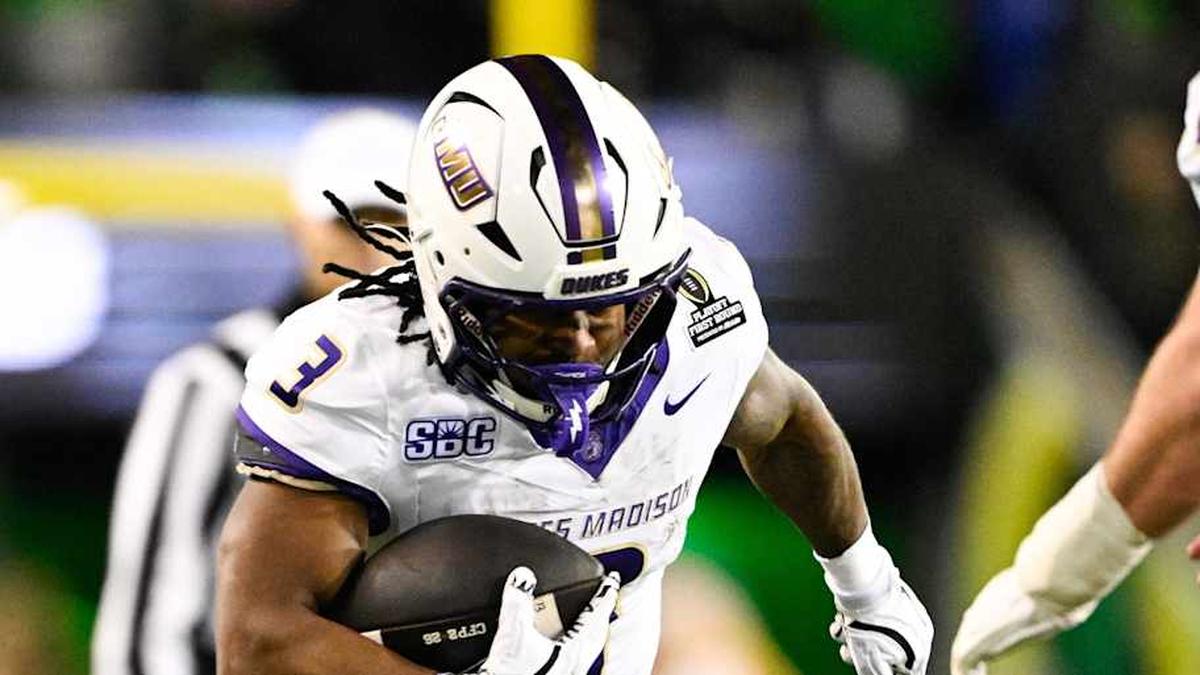  Dec 20, 2025; Eugene, OR, USA; James Madison Dukes running back Wayne Knight (3) rushes as Oregon Ducks defensive back Aaron Flowers (21) defends during the second quarter at Autzen Stadium. Mandatory Credit: Troy Wayrynen-Imagn Images | Troy Wayrynen-Imagn Images 