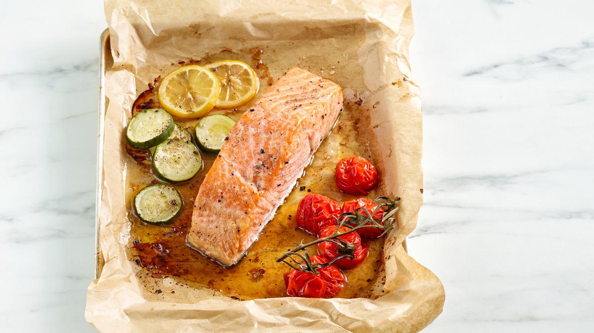 roasted salmon filet and vegetables on oven pan