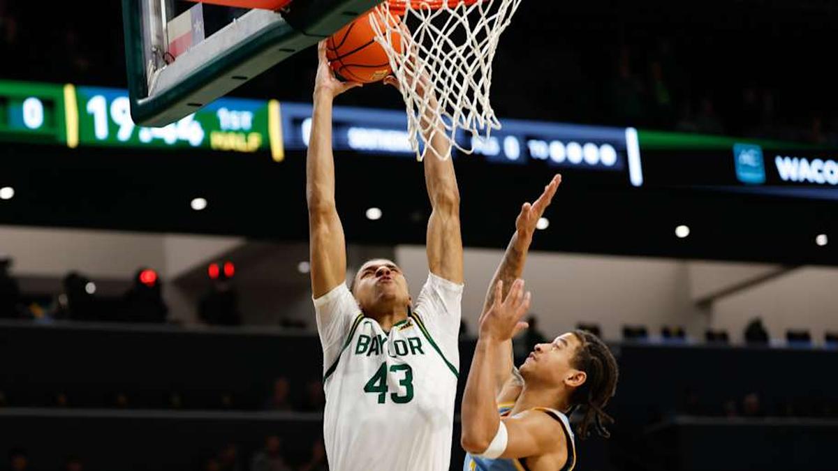  Dec 21, 2025; Waco, Texas, USA; Baylor Bears guard Cameron Carr (43) dunks the ball against Southern University Jaguars guard Cam Amboree (3) during the first half at Paul and Alejandra Foster Pavilion. Mandatory Credit: Chris Jones-Imagn Images | Chris Jones-Imagn Images 