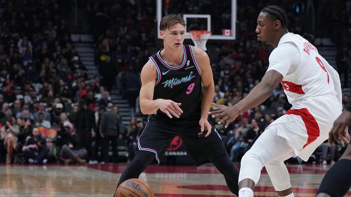  Apr 7, 2026; Toronto, Ontario, CAN; Miami Heat guard Pelle Larsson (9) controls the ball as Toronto Raptors forward RJ Barrett (9) defends during the first quarter at Scotiabank Arena. Mandatory Credit: Nick Turchiaro-Imagn Images | Nick Turchiaro-Imagn Images 