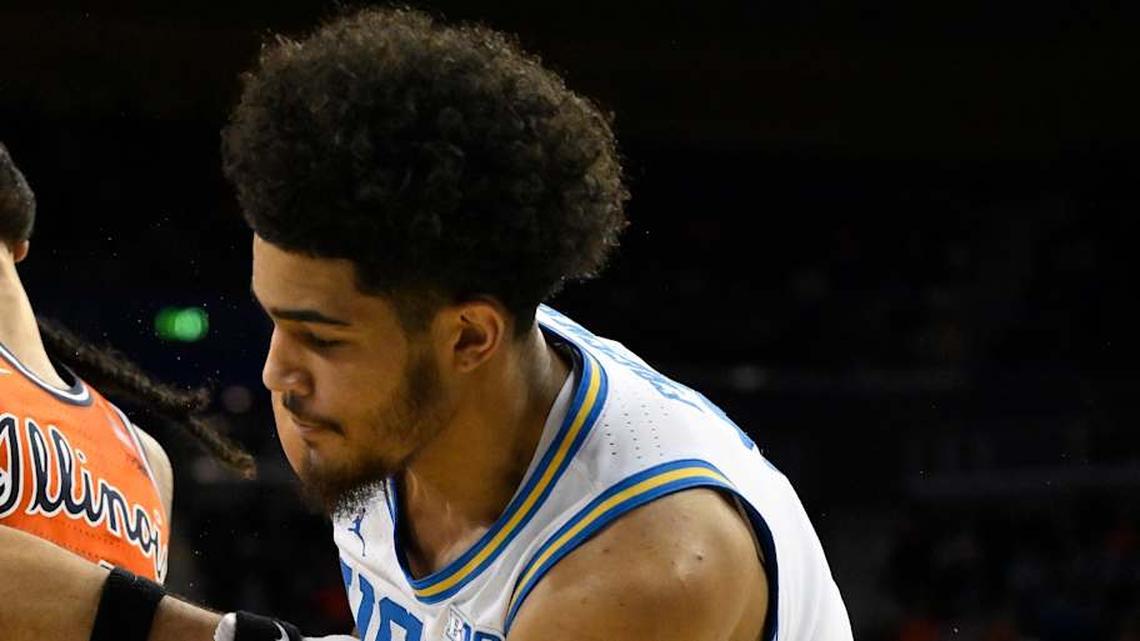  Feb 21, 2026; Los Angeles, California, USA; Illinois guard Kylan Boswell (4) and UCLA guard Eric Freeny (8) fight for the ball as UCLA guard Trent Perry (0) (left) looks on during the second half at Pauley Pavilion presented by Wescom Financial. Mandatory Credit: Robert Hanashiro-Imagn Images | Robert Hanashiro-Imagn Images 