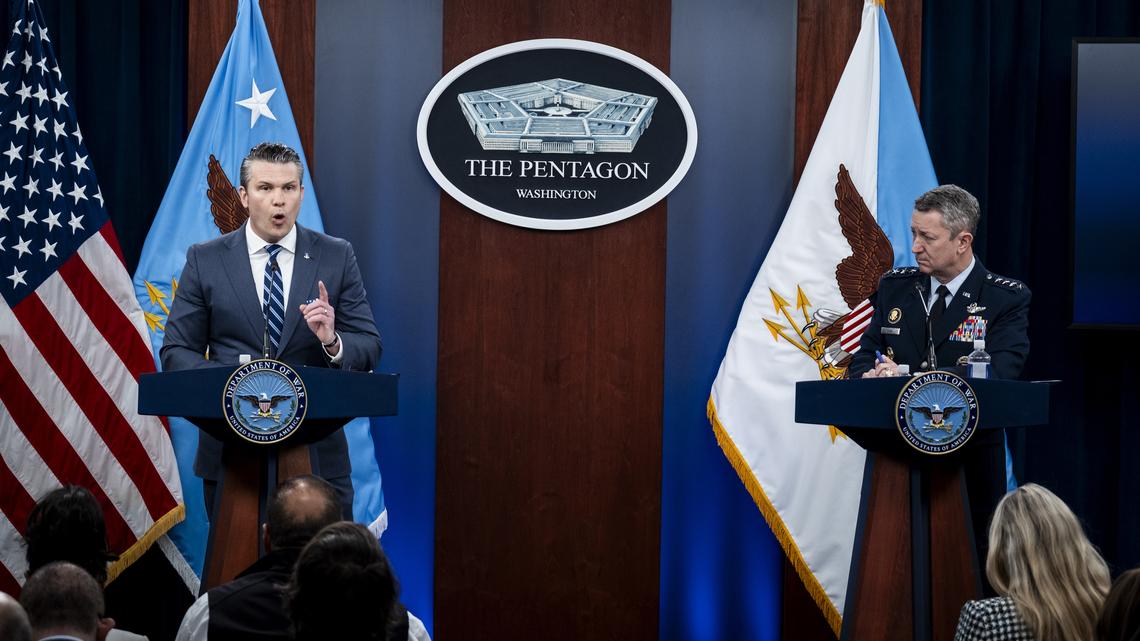 Secretary of Defense Pete Hegseth, left, and Chairman of the Joint Chiefs of Staff Gen. Dan Caine, right, provide updates on the war in Iran at the Pentagon in Arlington, Va., Thursday, April 16, 2026. (Pete Marovich/The New York Times)