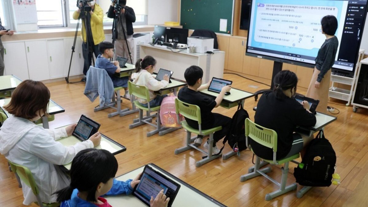 Pupils learn how to do division as they attend an open math class utilizing digital versions of print textbooks, provided on tablet computers with additional video and audio information, at Namsan Elementary School in Chuncheon, Gangwon Province, South Korea. Photo by YONHAP / EPA