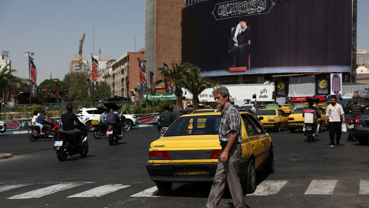 People move past a billboard with an image of Iran's late Supreme Leader Ayatollah Ali Khamenei in Tehran, Iran, June 30, 2026. Majid Asgaripour/WANA (West Asia News Agency) via REUTERS