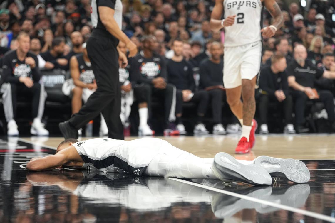  San Antonio Spurs forward Victor Wembanyama (1) lies on the court after falling to the ground during the first half of game two of the first round of the 2026 NBA Playoffs against the Portland Trail Blazers. Scott Wachter-Imagn Images