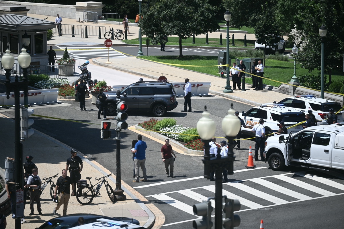  US Capitol Police officers and security personnel surround a vehicle that approached a security barricade near Constitution Avenue outside the US Capitol in Washington, DC, on July 13, 2026. 