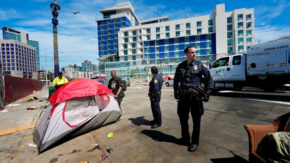 During a recent encampment sweep on National Avenue, Michael Lindsay relocates his tent to the other side of the street. San Diego conducts daily encampment abatements for public health and safety.  (Nelvin C. Cepeda/The San Diego Union-Tribune/TNS)
