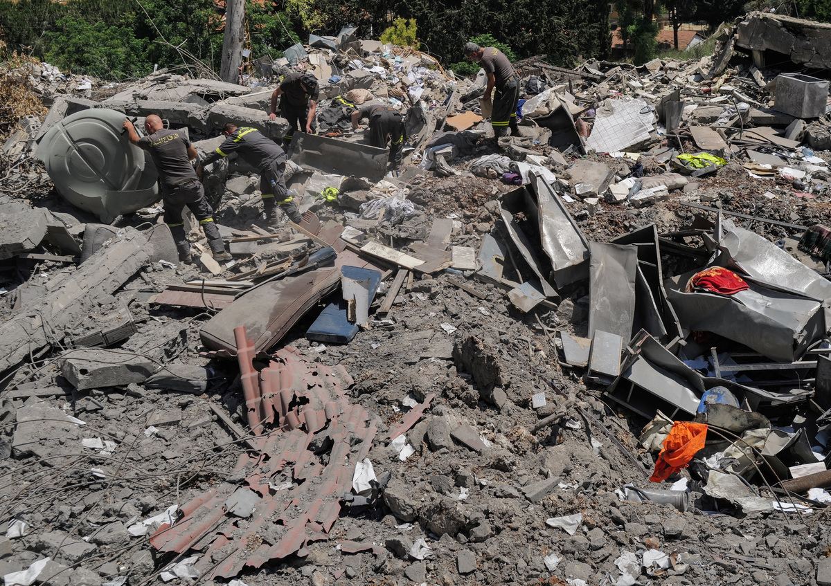 Members of the government-run Lebanese Civil Defense, the country's primary firefighting, first aid, and rescue force, search for belongings among the rubble while inspecting their headquarters in Nabatieh, Lebanon, June 17, 2026, following the deal between the United States and Iran. The headquarters was destroyed in an Israeli airstrike in May. REUTERS/Zohra Bensemra