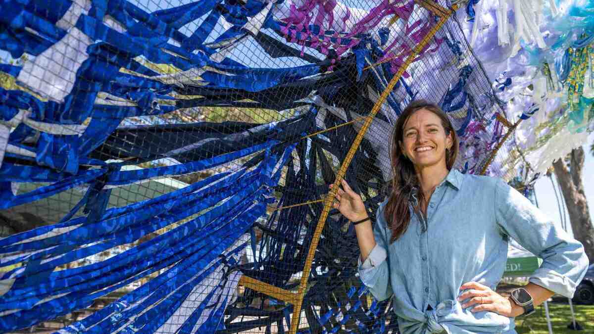 Artist Kacie Lyn Martinez stands next to her 8-foot artwork installment in the shape of a wave that will be on display at the Surf and Art Festival at Doheny State Beach over the weekend, in Dana Point on Friday, June 26, 2026. (Photo by Jeff Antenore, Orange County Register/SCNG)