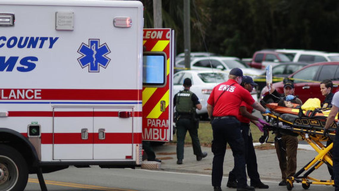 A person is transported from scene of the shooting at a Tallahassee yoga studio in 2018.