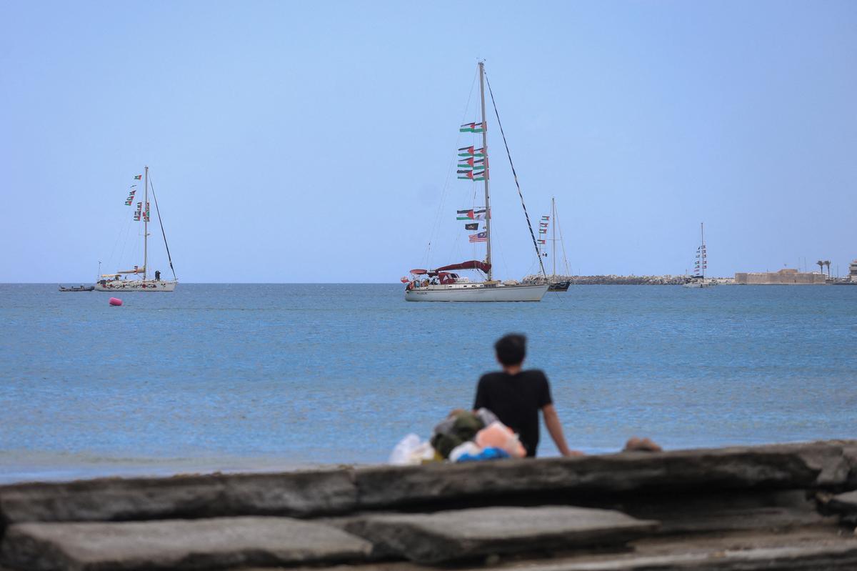 A man looks at vessels of the Global Sumud Flotilla, which was intercepted on international waters by the Israeli Navy, off the city of Ierapetra, on the island of Crete, Greece, May 1, 2026. REUTERS/Stefanos Rapanis