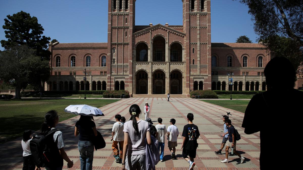 People walk through the campus of the University of California Los Angeles (UCLA) in Los Angeles, California, U.S., August 11, 2025. REUTERS/Daniel Cole