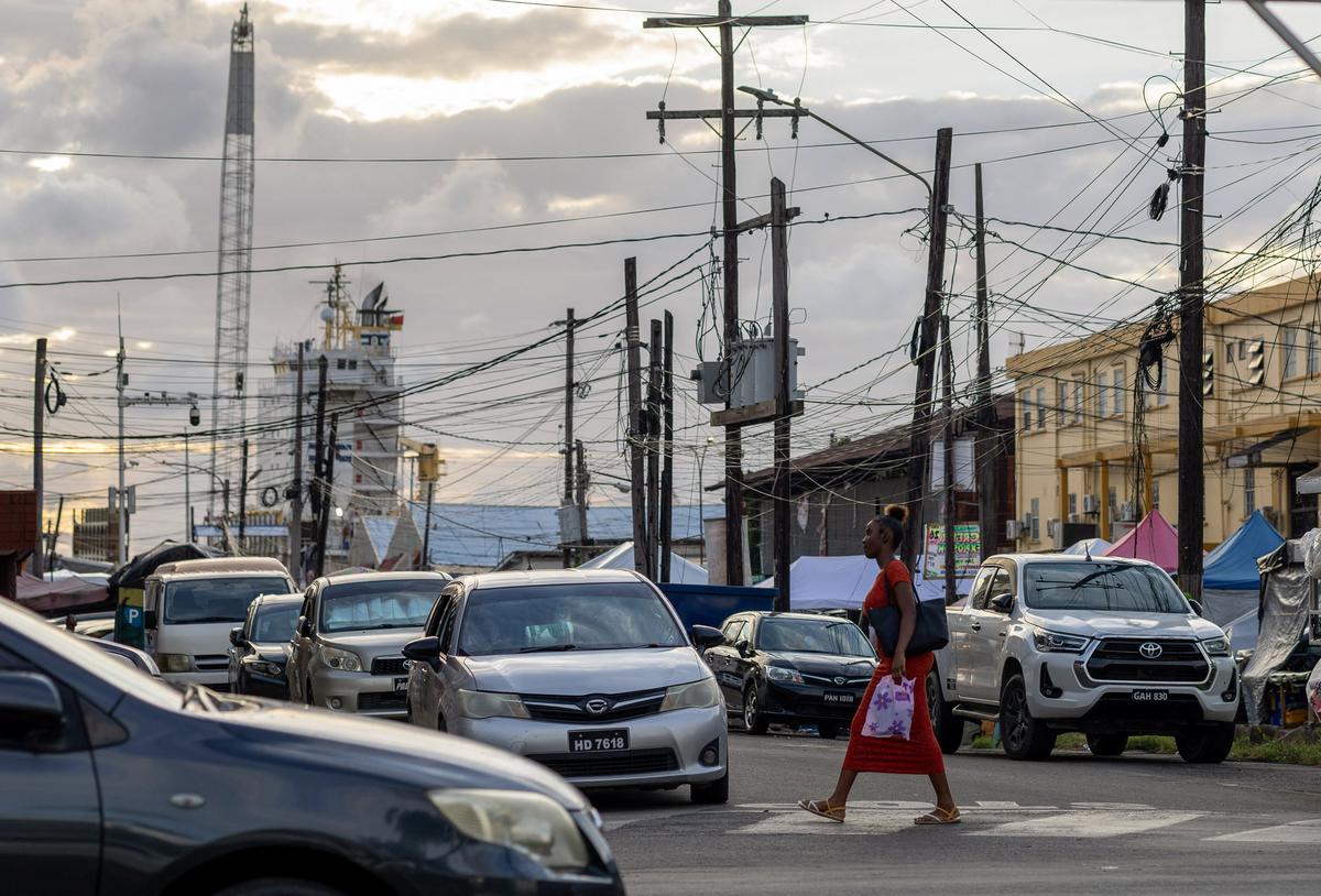 A woman walks on a street downtown, as Guyana's fast-growing economy is set to benefit from a reshaped global energy market due to the U.S.-Israeli war on Iran, in Georgetown, Guyana May 9, 2026. REUTERS/Yancey Haywood