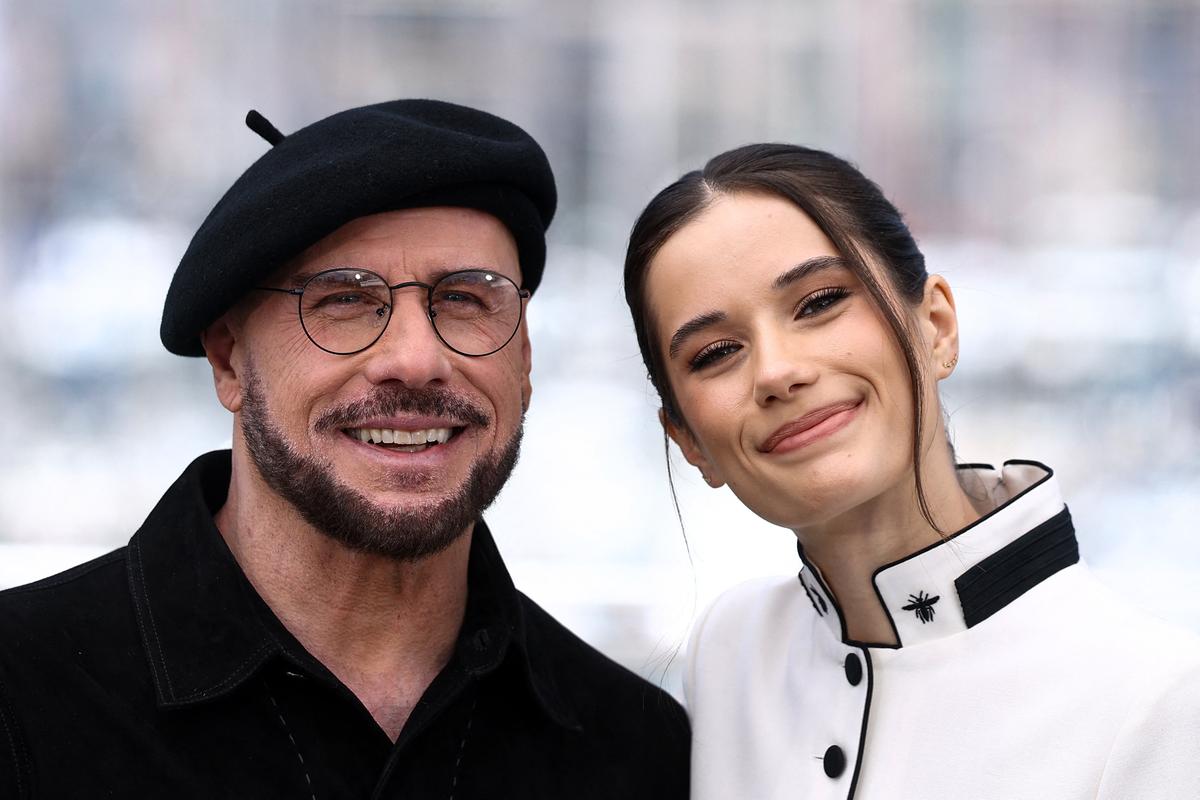 Director John Travolta and his daughter, a cast member Ella Bleu Travolta pose during a photocall for the film "Propeller One-Way Night Coach" (Vol de Nuit pour Los Angeles) presented as part of Cannes Premiere at the 79th Cannes Film Festival in Cannes, France, May 16, 2026. REUTERS/Manon Cruz
