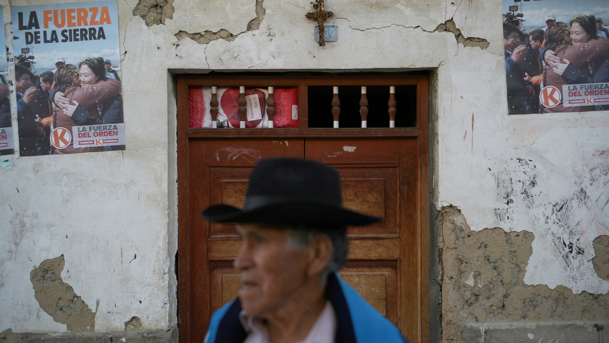 A person stands near signs showing conservative presidential candidate Keiko Fujimori in the town where voters backed Fujimori and leftist candidate Roberto Sanchez in the June 7 election in a rare close tie that mirrors a razor-thin national race, in Lahuaytambo, Peru, June 12, 2026. REUTERS/Alessandro Cinque     TPX IMAGES OF THE DAY