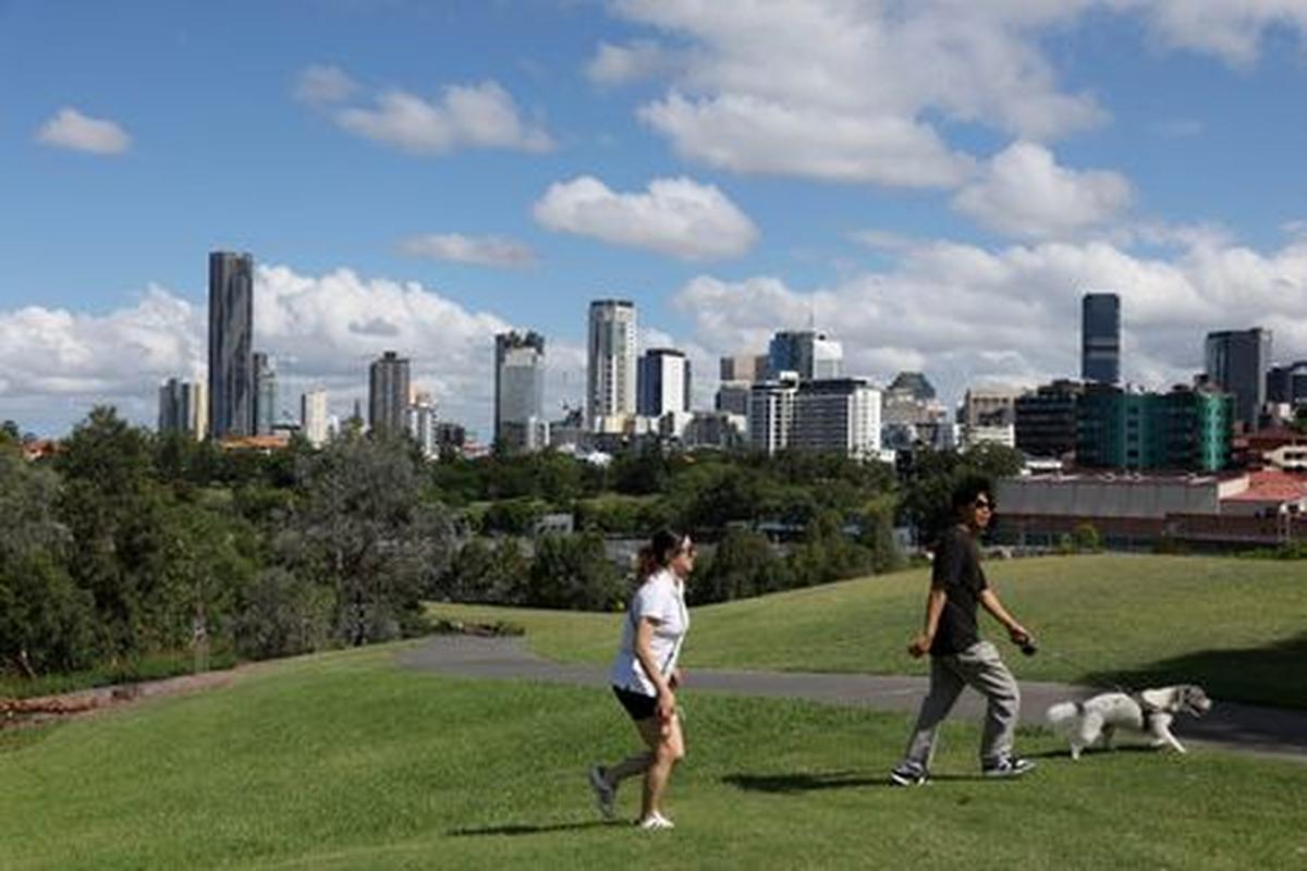 FILE PHOTO: People walk through Victoria Park-Barrambin, where the main stadium for the 2032 Olympics will be built, in Brisbane, Australia, December 8, 2025. REUTERS/Hollie Adams/File Photo