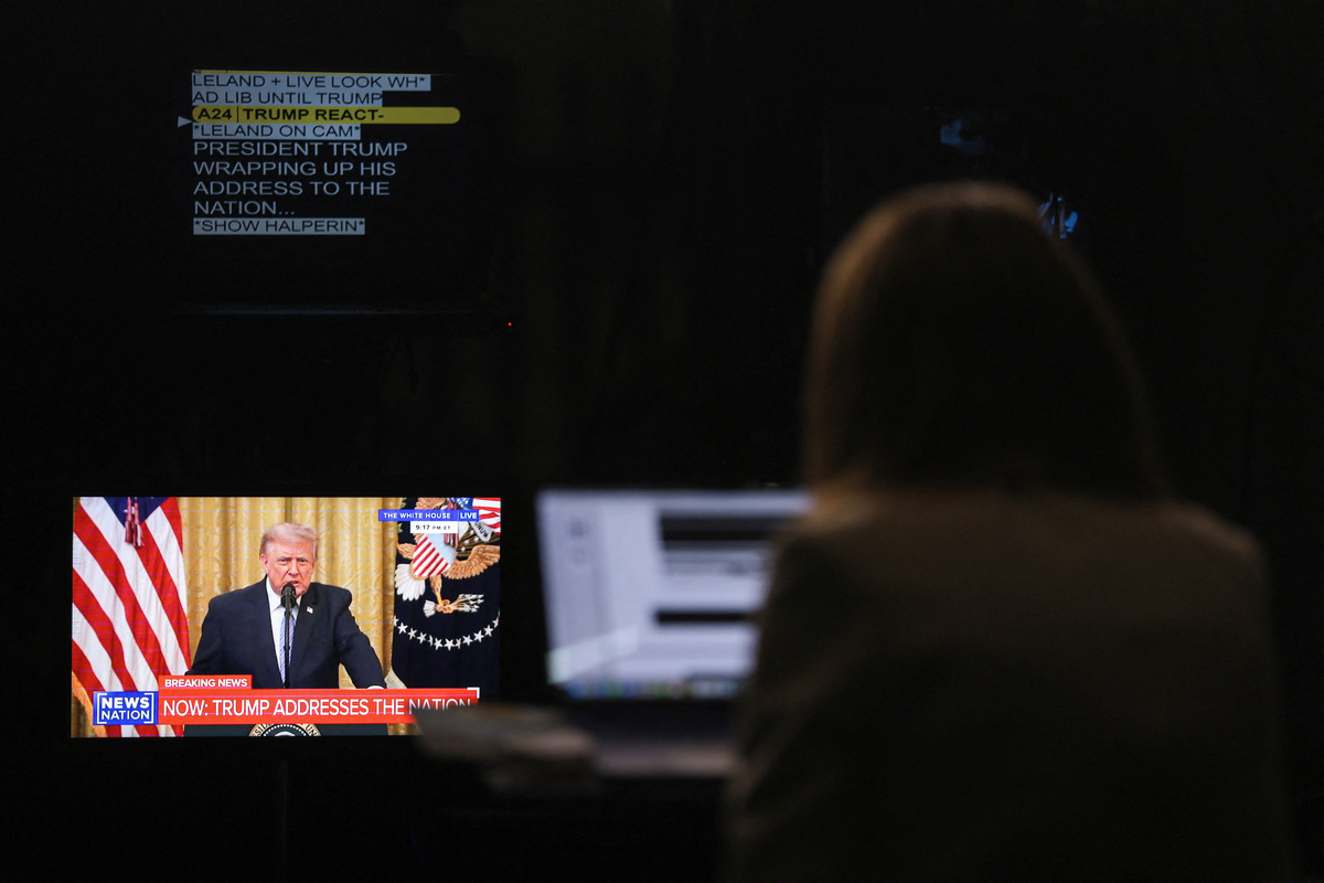 A journalist works as a screen displays U.S. President Donald Trump speaking about election security during an address to the nation from the East Room of the White House, in Washington, D.C., U.S., July 16, 2026. REUTERS/Kylie Cooper