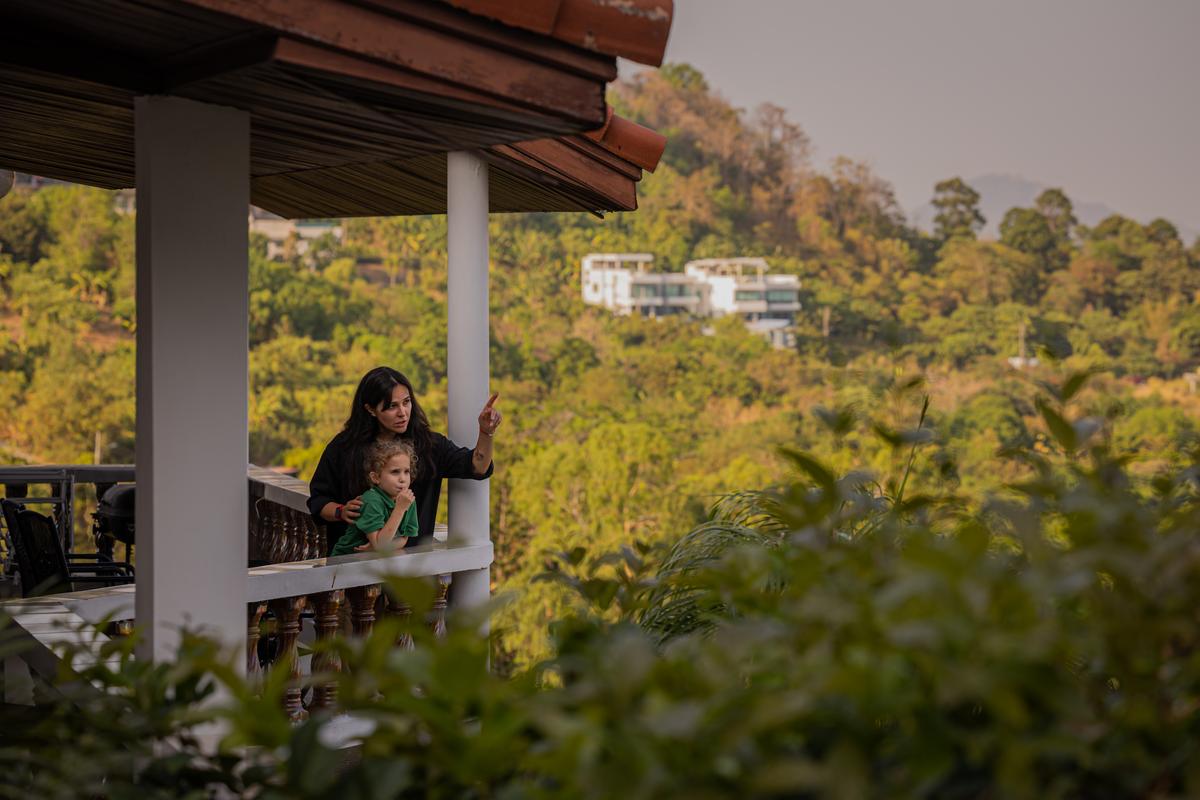 Ekaterina Mittsel, who moved to Phuket after Russia invaded Ukraine, and her daughter Alisa, 6, at their home in Rawai, Thailand on March 9, 2026. Thousands who fled Russia after the invasion of Ukraine have built an enclave in Phuket, though an air of impermanence hangs over their community. "We joke that we meet our friends here more often than we did in Moscow," Mittsel said. (Lauren DeCicca/The New York Times)..