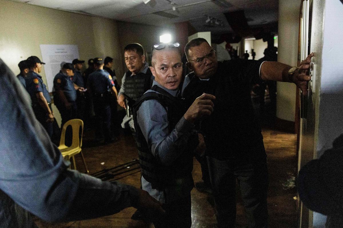 Senate security personnel stand guard, after gunshots were heard at the Philippine Senate, as chaos mounted in anticipation of an attempt to arrest a top senator wanted by the International Criminal Court, in Pasay City, Metro Manila, Philippines, May 13, 2026. REUTERS/Eloisa Lopez