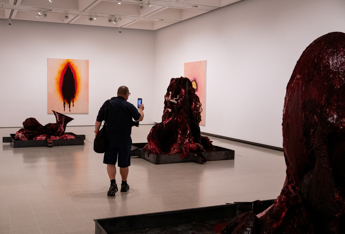 A photographer walks through a gallery during the press view for 'Anish Kapoor' at the Hayward Gallery, in London, Britain, June 15, 2026. REUTERS/Chris J. Ratcliffe