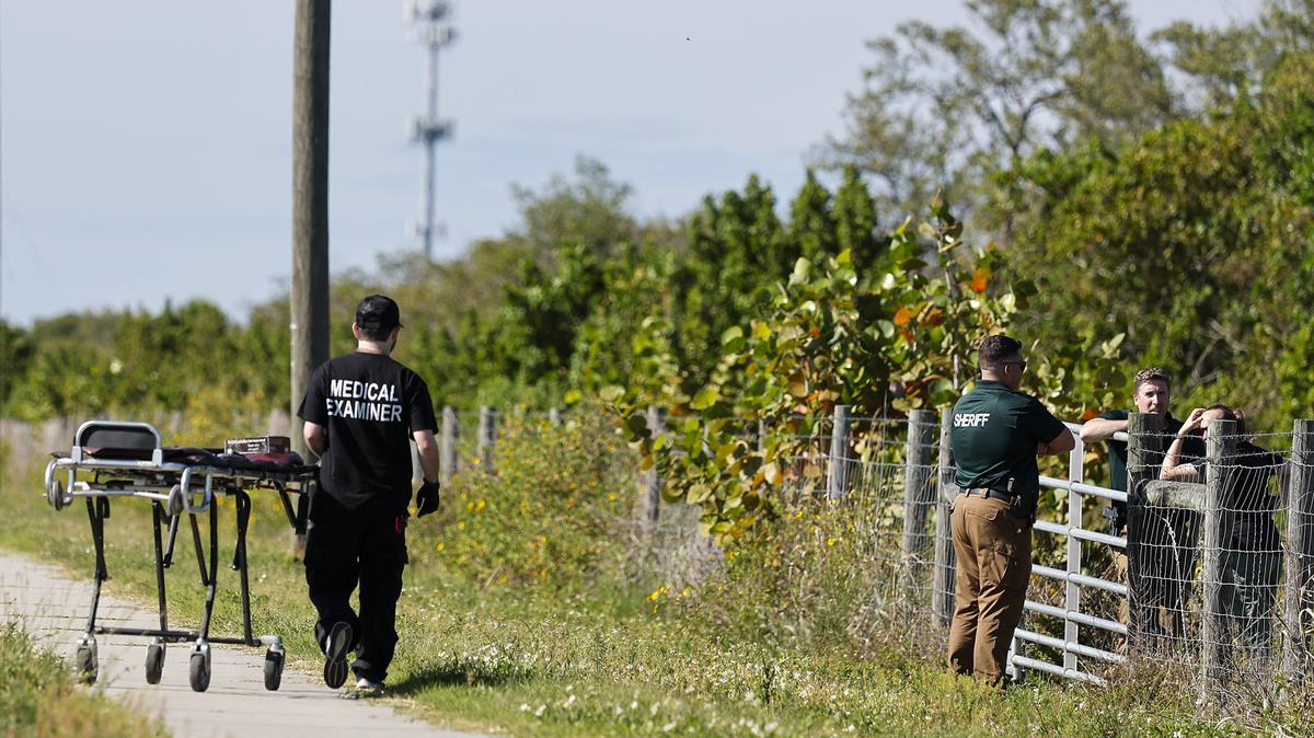 A medical examiner worker arrives Sunday, April 26, 2026, at the location where human remains were found on Fourth Street North near the Howard Frankland Bridge. (Luis Santana/Tampa Bay Times/TNS)